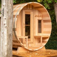 a wooden barrel sauna in the woods