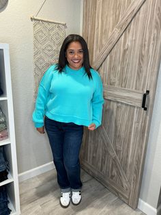 "Get cozy in style with this Aqua Blue Pullover Knit Mock Neck Sweater! Its cropped and oversized fit will keep you both warm and on-trend. Perfect for pairing with high-waisted jeans and boots for a relaxed yet chic look.(No itchy necks here!) Sizing is true to size, I'm in a size large for the perfect cozy feel. Blue Cropped Sweater With Ribbed Cuffs For Fall, Casual Cropped Sweater With Cozy Fit, Casual Cozy Fit Cropped Sweater For Fall, Comfortable Blue Sweater For Fall, Trendy Blue Sweatshirt For Fall, Oversized Blue Cropped Sweater, Blue Sweatshirt For Fall, Oversized Blue Cropped Sweater For Winter, Trendy Medium Wash Top For Winter