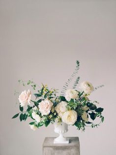 a vase filled with white flowers on top of a table