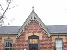 a red brick house with wreaths on the front door