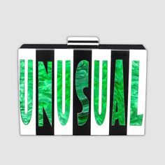 Embrace your weird and wild side with this sleek acrylic Cyndi clutch that features pearlized green letters spelling out "Strange" on one side and "Unusual" in the same gorgeous swirled green on the other side. Black and white stripes and a black and white top latch set off the letters in style. With plenty of space inside for your night-out essentials (any cell phone, keys, lipstick, and our slim Card Wallet), and a removable gold metal chain shoulder strap, this clutch is a versatile and uniqu Green Letters, Strange And Unusual, Acrylic Clutch, Black And White Top, Black Liner, Black And White Tops, Black And White Stripes, White Acrylics, Magnetic Clasp