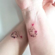 two small tattoos on the arms of someone's hands, one with hearts and stars