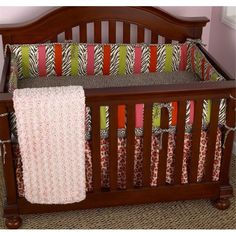 a baby crib in a room with pink walls