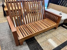 a wooden bench sitting on top of a tiled floor