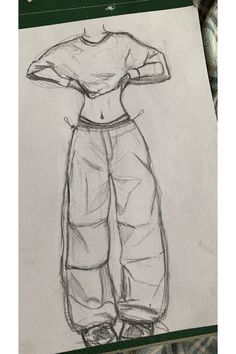 a drawing of a woman's shirt and pants on a piece of white paper