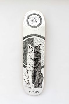 a white skateboard with an image of a wolf on it's back side