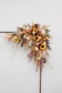 an arrangement of dried flowers on a stick