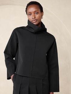 Modern Funnel Neck Top For Fall, Chic Funnel Neck Outerwear For Work, Oversized Turtleneck Top For Work, Modern High Neck Tops For Workwear, Sleek Turtleneck Tops For Work, Funnel Neck Tops For Fall Workwear, Fall Funnel Neck Workwear Top, Sleek High Neck Top For Workwear, Modern Tops With Minimal Stretch For Work