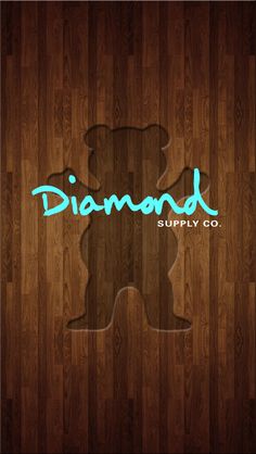 the logo for diamond supply co on a wood background with a bear cut out from it