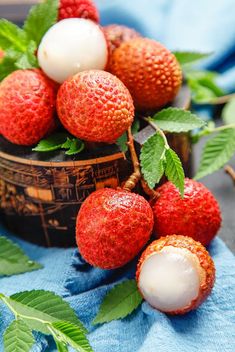 strawberries and other fruit on a blue cloth