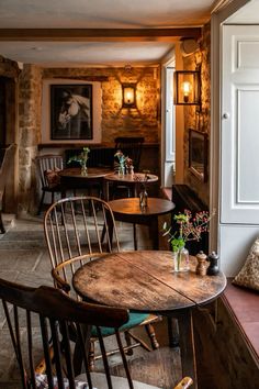 the interior of a restaurant with wooden tables and chairs