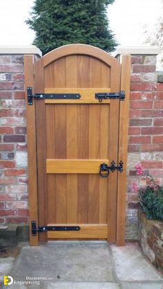 a wooden gate with black hardware on it