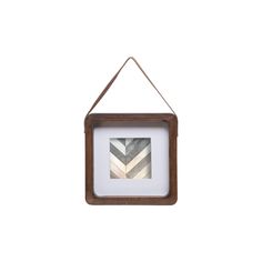 a wooden frame hanging on a wall with a white and grey striped pattern in it