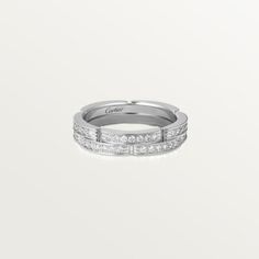 a white gold wedding band with princess cut diamonds on the sides and channeled edges