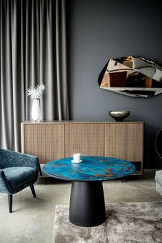 a living room filled with furniture and a mirror on the wall above it's coffee table