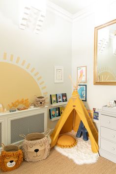 a child's bedroom with a teepee tent and stuffed animals