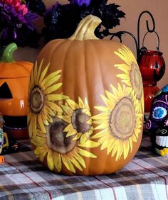 a pumpkin with sunflowers painted on it