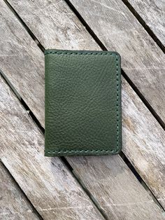 "- 100% full grain vegetable tanned leather (except for thread) from the Badalassi Carlo Tannery in Tuscany, Italy. - Leather is medium temper. - Wallet exterior (main panel) is an Emerald GREEN with a pebbled finish. - Interior leather pockets are SADDLE TAN BROWN with a smooth finish from the same Italian tannery. - DARK GREEN leather edge sealant applied. - Dimensions when closed; nominally 3\"x4\" - readily fits in most front pockets. Easily fits in pants pocket, purse, etc. - 4 card slots. Will accept more than 4 cards as well as folded cash - Wallet pieces are hand-cut and hand stitched together. Hand stitching takes longer but is a more durable assembly. - This leather has Limited Availability. - This Vegetable Tanned Leather comes from the Badalassi Carlo Tannery in Tuscany, Italy. Hand-stitched Leather Card Holder For Everyday Use, Green Leather Card Holder For Everyday Use, Leather Card Holder With Waxed Finish, Leather Wallets With Card Slots, Classic Green Leather Trifold Wallet, Vegetable-tanned Trifold Wallet For Daily Use, Daily Use Vegetable-tanned Trifold Wallet, Handmade Green Leather Trifold Wallet, Leather Card Holder With Waxed Finish For Everyday Use