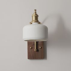 a wall light with a white shade on it