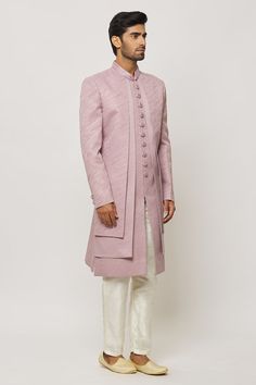 Lilac pink layered sherwani with thread work and statement buttons in art silk base. Paired with a cream aligadi pant. - Aza Fashions Pink Sherwani, Types Of Work, Lilac Pink, Work Jacket, Work Jackets, Band Collar, Thread Work, Churidar, Pant Set