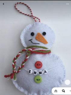 a snowman ornament hanging from a string