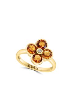 Show off dazzling sparkle in this 14-karat yellow-gold flower ring featuring semiprecious stone petals centered by a dainty bezel-set diamond. 1/2" diameter setting Total diamond weight: 0.02ct. Color: H–I Clarity: I1–I2 14k gold/citrine, London blue topaz, amethyst and/or peridot/diamond Made in the USA Diamond Guide Diamond Flower Ring, Gold Flower Ring, Diamond Guide, Bezel Set Diamond, Diamond Flower, Gold Flower, London Blue Topaz, London Blue, Flower Ring