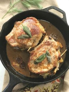 two pieces of meat in a skillet on a table