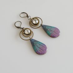 I love the details of the liquid looking metallic artisan polymer clay drops and wanted to really make them stand out as a statement piece. They have rings of brass crowned with a dazzling rhinestone, giving these earrings movement and attention. These earrings are fairly lightweight and measure about 3 inches from end to end with euro back ear wires. These earrings will arrive gift boxed for safe travels shipped inside a bubble mailer. Thank you for checking out my Etsy shop! -Nova Leigh Smoky Crystal, Punk Earrings, Safe Travels, Fringe Necklace, Crystal Prisms, Bubble Mailer, Copper Necklace, Modern Earrings, Brass Earrings