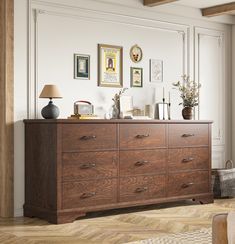 a large wooden dresser in a room with pictures on the wall