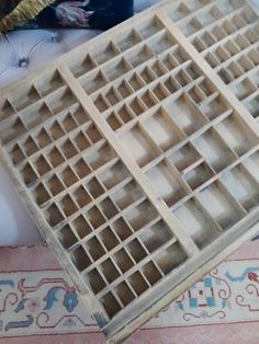 a large wooden shelf sitting on top of a rug