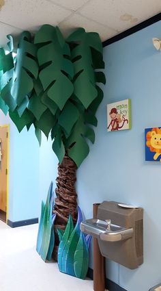 a classroom with blue walls and paper decorations on the wall, including a palm tree