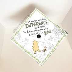 a graduation cap with winnie the pooh on it and some words written in black ink