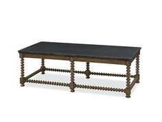 a wooden table with black leather top and beading around the edges, on a white background