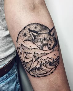 a black and white tattoo of a fox on the arm