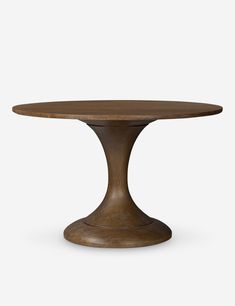 a round wooden table with an iron base and wood grained finish on the top