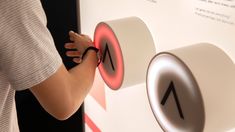 a person is pressing buttons on a wall