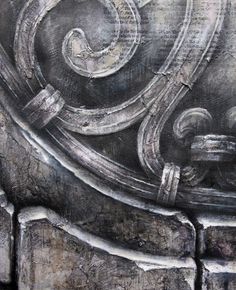 an artistic painting on the side of a building in black and grey tones with swirls