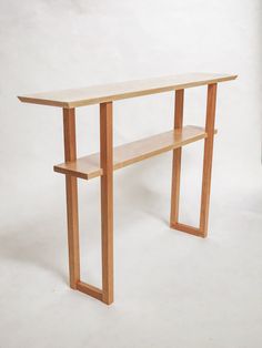 a wooden table sitting on top of a white floor