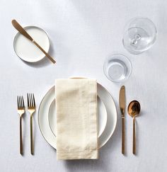 a place setting with silverware and napkins