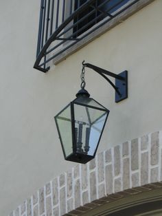 a light hanging from the side of a building