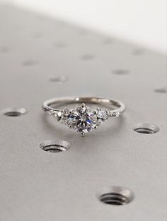 a diamond ring sitting on top of a metal surface