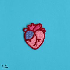 an embroidered heart on a blue background