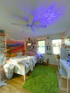 a bedroom with a bed, desk and ceiling fan in it's center area