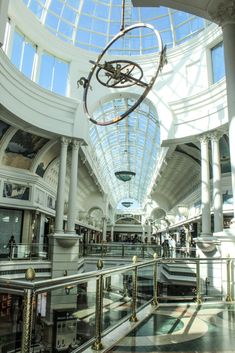 the inside of a shopping mall filled with lots of furniture and decorations, including a chandelier hanging from the ceiling