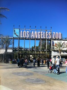 people are walking around in front of the los angeles zoo