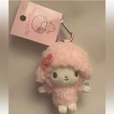 a hello kitty keychain with a pink poodle on it's head