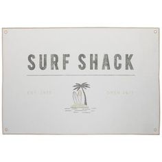 a sign that says surf shack with palm trees on the beach in front of it