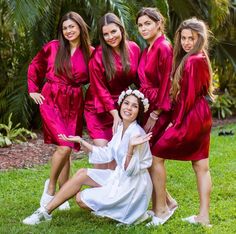 a group of women in red robes posing for a photo