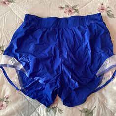 a pair of blue shorts laying on top of a bed