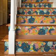 the stairs are decorated with colorful floral wallpaper